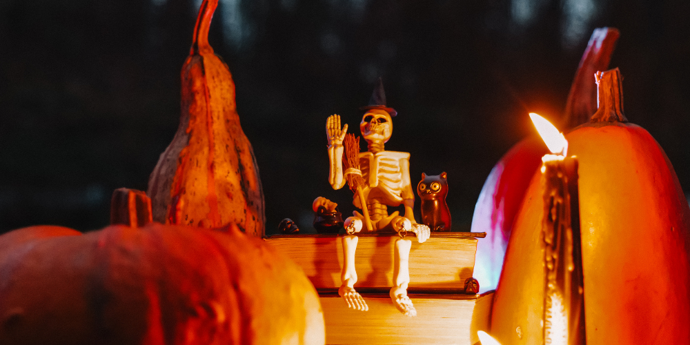 skeleton and pumpkins with books