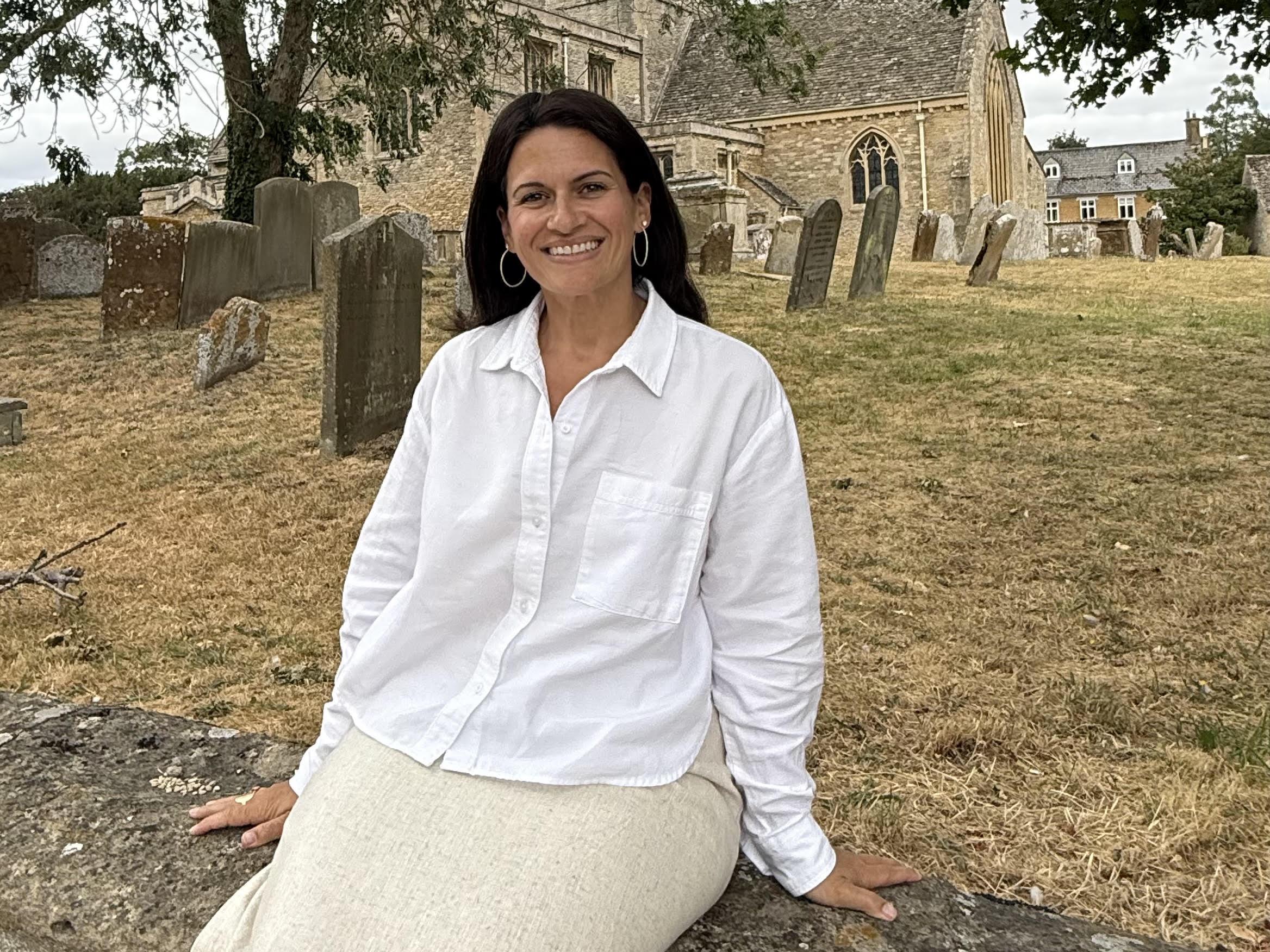 woman sitting on rock wall